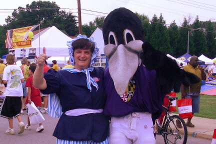 Kathy Reiner Martin with the Ravens mascot at the Perry Hall Town Fair